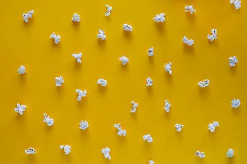 Popcorn pattern on yellow background. Top view. Contrast concept. popcorn on Stock Photos