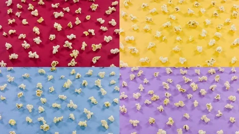 Popcorn pattern on yellow, blue, red background. Top view. Closeup rotation Stock Footage 76756584