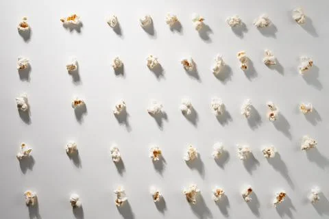 Popcorn piece on gray background. Stock Photos