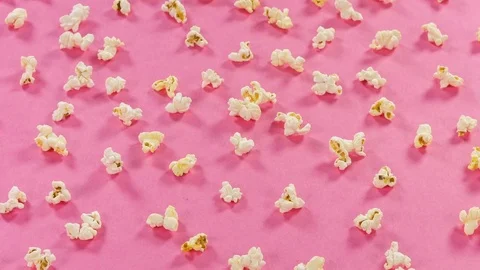 Popcorn on pink background. Top view and close up rotation. Stock Footage 76589573