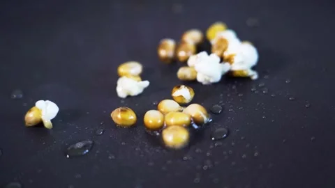 Popcorn popping, exploding in slow motion in pan, close-up detail shot Stock Footage 276594620