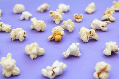 Popcorn on purple background Stock Photos