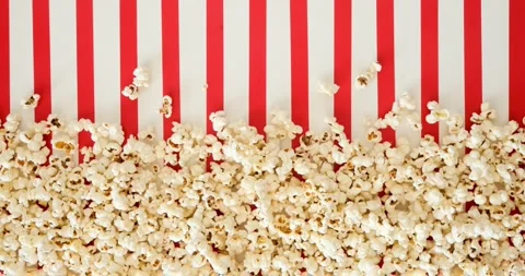 Popcorn on a red-and-white striped background. 4K stop motion animation Vídeos de archivo 345118638