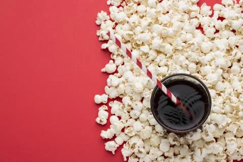 Popcorn on red textured background Stock Photos