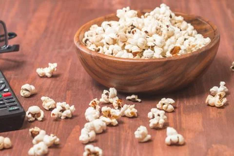 Popcorn, remote control and 3D glasses Stock Photos