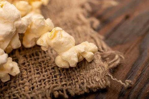 Popcorn scattered on the table. Self-isolation in the covid-19 pandemic. Stock Photos