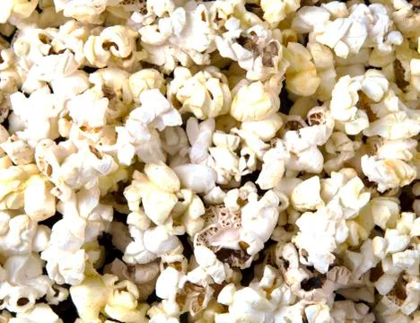 Popcorn texture background on dark table Stock Photos