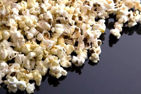 Popcorn texture background on dark table Stock Photos