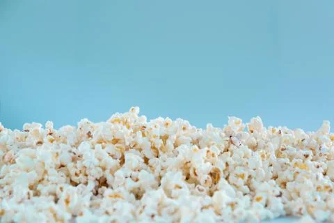 Popcorn texture on a blue background Stock Photos