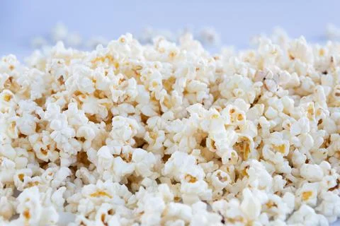 Popcorn texture on a blue background Stock Photos