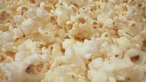 Popcorn tumbles towards camera into a macro shot. Stock Footage 130996710