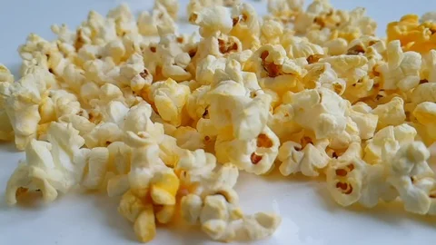 Popcorn on a white background drops, slow-motion shot Stock Footage 89765450