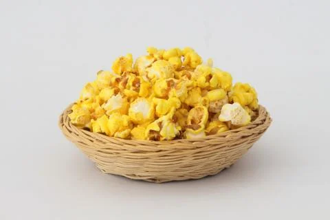 Popcorn in wicker basket. Stock Photos