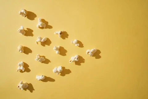 Popcorn on a yellow background. Copy space. Pop corn collection. Stock Photos