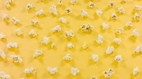 Popcorn on yellow background. Top view and close up rotation. 스톡 동영상 76589532