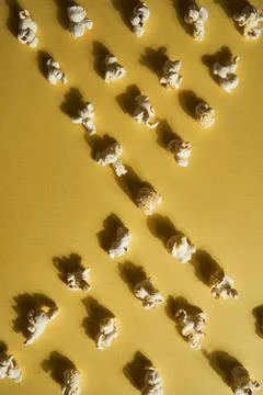 Popcorn on a yellow background.Copy space. Pop corn collection. Different siz Stock Photos
