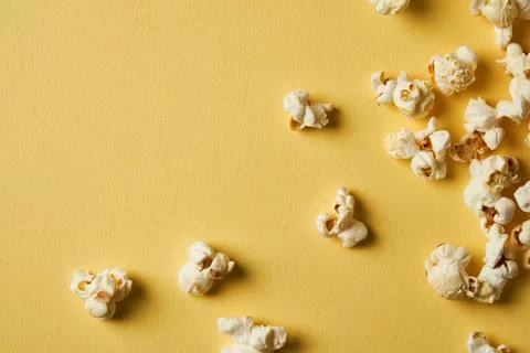 Popcorn on a yellow background.Copy space. Pop corn collection. Different siz Stock Photos