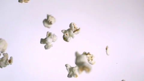 Popcorns falling down in slow motion against white background 스톡 동영상 81231151
