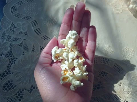 Popcorns on hand Stock Photos