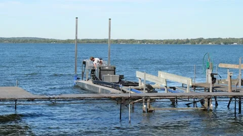 POPE CO, MN - 23 SEP 2021: Forklift barge is used to carry a boat lift. Stock Footage 162600136