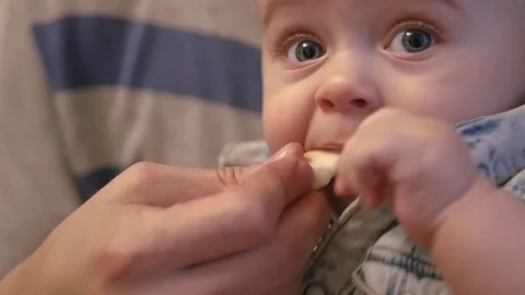 The pope holds a small son in his arms and helps him to eat delicious food. slow Video stock 82991584