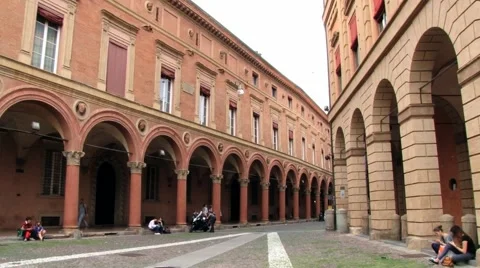 Pople walk by the arcade at Piazza Santo Stefano in Bologna, Italy. Stock Footage 59792847