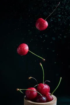 Popsicle with fresh cherries on a dark background, dynamic shot with action,  Stock Photos