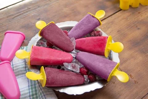 Popsicles on rustic wooden table Stock Photos