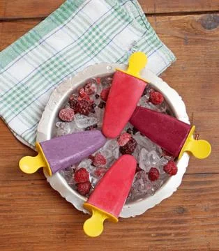 Popsicles on rustic wooden table Stock Photos