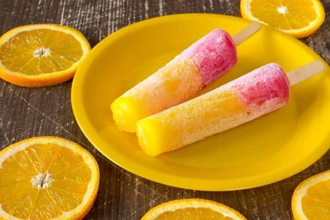 Popsicles with sliced orange fruit Stock Photos