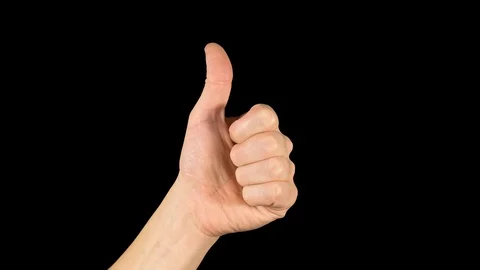 Popular hand gesture. Thumbs up on isolated dark background. Stock Footage 119551853