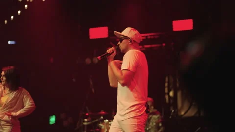 Popular rapper is rapping on stage, gig of trendy young musicians in music hall Vídeos de archivo 218365074