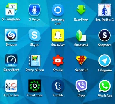 Popular social media and application icons on the screen of smartphone Stock Photos