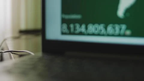 Population number growing on laptop screen. Interactive counting of world Stock Footage 272656909