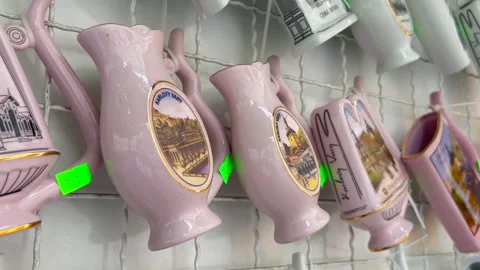 Porcelain cups for drinking natural spring water on the stands of the souvenir Stock-Footage 253189322