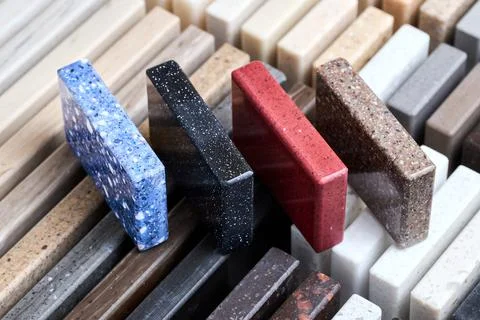 Porcelain four stoneware square samples laid on kitchen countertop examples of Stock Photos