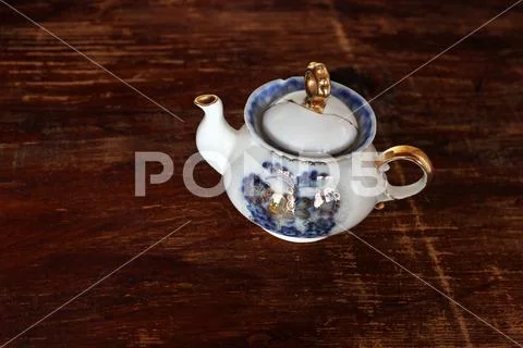 Porcelain teapot on wooden background Stock Photos