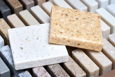 Porcelain two stoneware square samples laid on kitchen countertop examples of Stock Photos