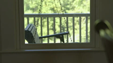 Porch swing from inside farm house Stock Footage