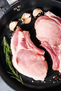 Porco Iberico French Racks in frying pan with herbs, spices close up grey Stock Photos