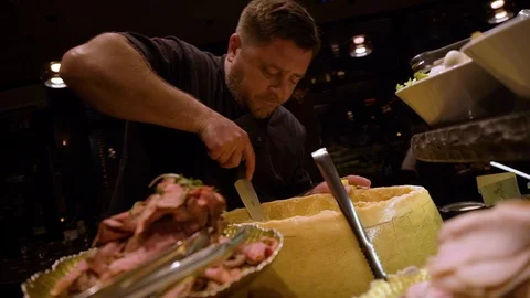 Porftrait of chef choping big parmesan wheel. Chef cooking at salad bar Stock-Footage 104018094