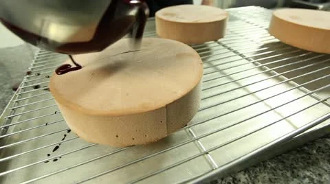 Poring chocolate over cake Stock Footage 11473524