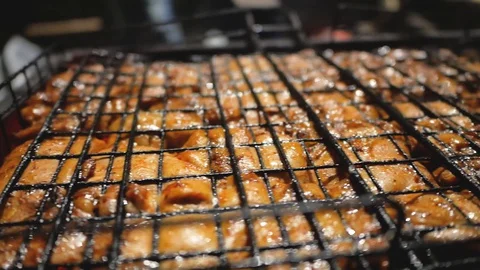 Pork and beef meat is fried on grills Stock Footage 129572819