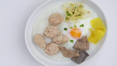 Pork And Boiled Egg Rice Porridge With Ginger Slice In White Bowl Rotated. Stockbeeldmateriaal 247446601