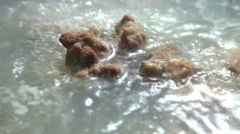 Pork and bone cooking in pot with boiling water Stock Footage 41661203