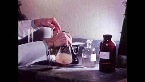 Pork is artificially digested to test for the parasite Trichinosis in the 1940s Stock Footage 101310876