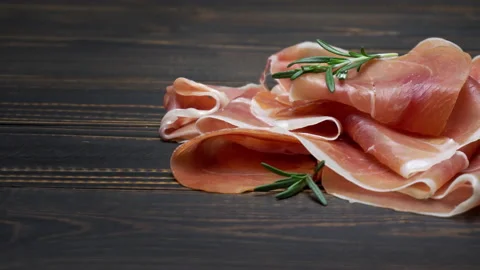 Pork bacon slice on back wooden cutting board. Slow motion Stock Footage 133605330
