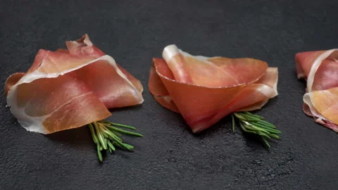 Pork bacon slice on back wooden cutting board. Slow motion Stock Footage 133605428