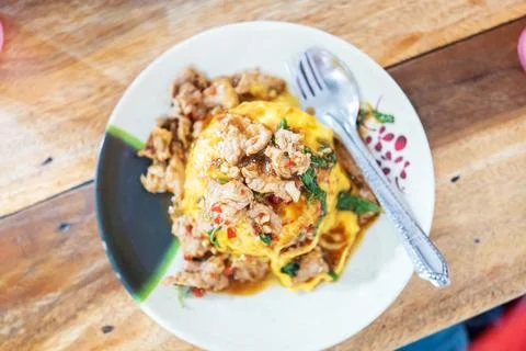 Pork Basil with Egg on table with soft light . Stock Photos