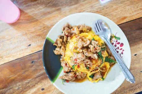 Pork Basil with Egg on table with soft light . Stock Photos